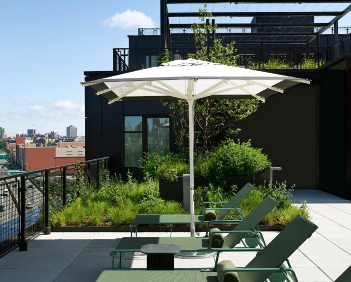 Furnished outdoor amenity decks with sweeping Harlem River views at Estela apartments in Mott Haven