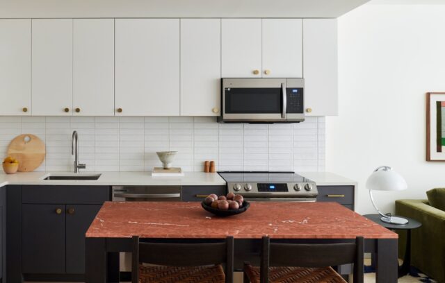Open kitchen with white cabinets and microwave at Estela in the South Bronx Mott Haven neighborhood